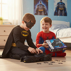 4D Build DC Batman Retro Batmobile 3D Puzzle Model Kit is featured as two boys in costumes play together on a carpeted floor.