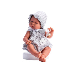 Doll in gray plaid dress and bonnet, seated with a pacifier holder.