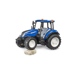 Blue New Holland T5.120 toy tractor on rocky terrain, featuring large black tires and detailed design.