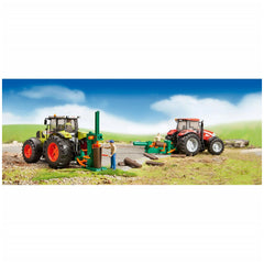 Toy forestry set with two tractors, figures using log splitters and tools, on a grassy, rocky landscape under a blue sky.
