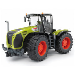 Bright green Bruder Claas Xerion 5000 toy tractor with red wheels and detailed design on a light background.