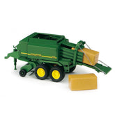 Green John Deere Big Balepress toy with yellow wheels and hay bales, detailed design, side view.