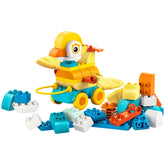 Colorful LEGO construction set featuring a duck on wheels, surrounded by various interlocking blocks in blue, orange, and white.
