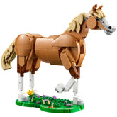 Posable LEGO horse figure in brown, standing on a green grass-effect base with flowers, showcasing dynamic features and creativity.