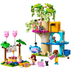 Colorful LEGO set featuring a tree house with a cat theme, birthday decorations, two minidolls, and playful cat figures.