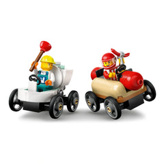 Two LEGO® City soapbox race cars side by side: one with a yellow helmeted driver holding a plunger, and the other with a red-helmeted driver.