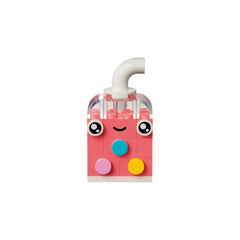 Bright pink LEGO® construction set piece resembling a cheerful drink cup, featuring large eyes and a smile, with colorful round accents.