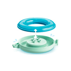 Floating animal train accessory with a bright turquoise outer ring and a soft green base, featuring water spray elements.