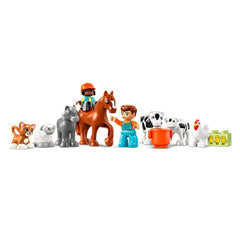Two children interact joyfully with a brown horse, surrounded by various animal figures, including a cat, sheep, gray horse, cows, a chicken, and a barn accessory.
