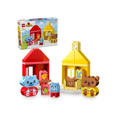 Colorful LEGO® DUPLO® My First Daily Routines set featuring two houses, a red and a yellow one, alongside animal figures: a blue kitten, a bear cub, and accessories like a banana and pear.