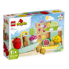 Colorful LEGO® DUPLO® Organic Market set featuring cheerful fruits, vegetables, and toy coins in a playful farm market scene.