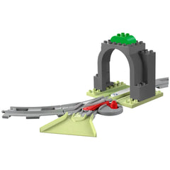 LEGO® DUPLO® Train Tunnel and Tracks Expansion Set featuring a gray tunnel with a green top, paired with a 10-piece track layout including a two-way points switch and a funnel element.