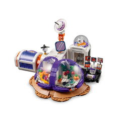 LEGO® Friends Mars Space Base set featuring colorful domes and a rocket, equipped with plants, tools, and mini-doll figures.