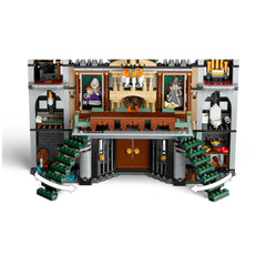 Intricate interior of the LEGO Harry Potter Malfoy Manor set, showcasing two green staircases, a fireplace, and detailed rooms with character portraits.