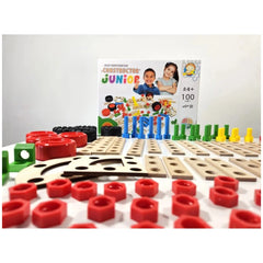 Constructor Junior 100-piece set with colorful screws, connectors, and wooden boards, box featuring cheerful children.