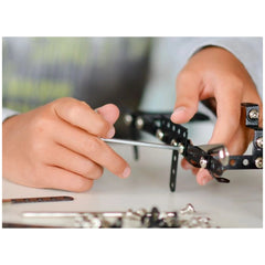 Child assembling metal and plastic components with a screwdriver from Alexander Maly Constructor Expert Pickup Van Set.