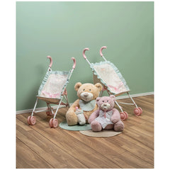 Toy strollers with pink handles beside two plush teddy bears on wooden floor, against a soft green wall.