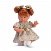 Red-haired doll with pigtails, wearing a green flower dress and bows, posed sitting with bent arm and white socks.
