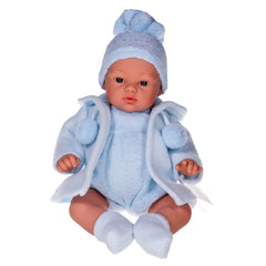 Koke doll in blue knit outfit with hat and coat, sitting with lifelike features and open eyes.