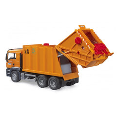 Orange Bruder MAN TGS garbage truck toy with open rear loader and detailed cab, set on a white background.