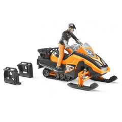 Orange snowmobile toy with driver in helmet, featuring dual-axle suspension, steering, and two black accessories beside it.