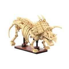 Cada Dinosaur Fossil Triceratops construction set made of tan Lego bricks on a black base, displayed in a front view.