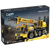 CaDA mobile crane truck construction set in yellow with black and orange accents, displayed in matte cardboard packaging agai
