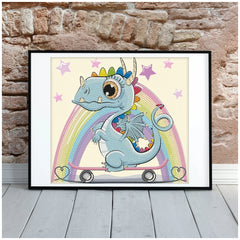 DOTZIES Dragon Skate diamond painting featuring a rainbow-maned dragon on a skateboard with a white wooden frame against a br