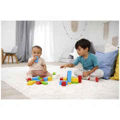 Eichhorn coloured wooden blocks scattered on the floor as two children play with toys in a cozy, gray-themed living room.