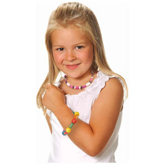 Eichhorn Wooden Bead Set - 275 colorful beads showcased on a smiling girl wearing a colorful beaded necklace.