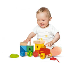 Eichhorn wooden train set with colorful carriages, featuring a happy toddler engaging with the toys on a white floor.