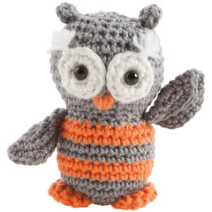 Mini crochet kit featuring a gray and orange striped knitted owl with black plastic eyes and an orange beak.