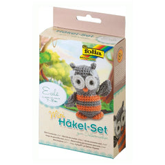 Folia Mini Crochet Kit features a gray owl with orange and white accents, visible crochet hook, and clear plastic window on m