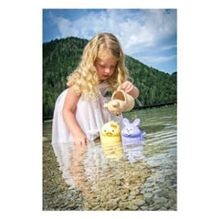Gowi beach toys in a lifestyle scene featuring a girl with blonde hair playing near water.
