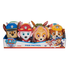GUND Paw Patrol plush toys in various colors, featuring soft fabric and distinctive character hats, arranged on a white backg