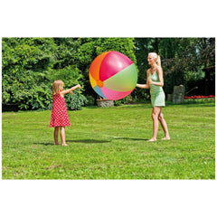 Happy People Beach Ball XXL 85 cm held by a woman in a green dress with a girl in a red polka dot dress on vibrant green gras