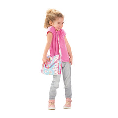 Heless changing bag features a floral-patterned pink bag held by a girl in a pink shirt, gray pants, and pink shoes.