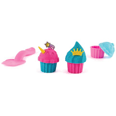 Kinetic-Sand Unicorn Bake Shoppe features colorful plush cupcakes in pink, blue, yellow, and green against a white background
