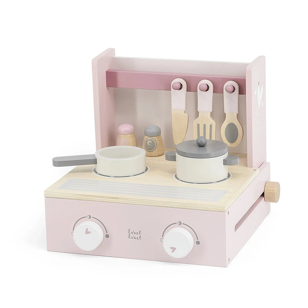Foldable cooker toy in light pink with white and gray knobs, spools, and handles, featuring a lid and drawer.