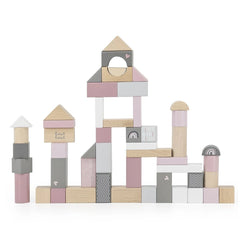 Wooden stacking toys featuring pink and white blocks, arranged in a playful layout with cardboard and plastic elements.