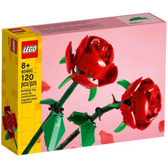 LEGO® Creator Botanical set featuring two vibrant red roses with green leaves and adjustable stems, set against a soft pink background.