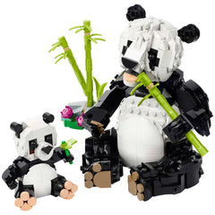 A detailed LEGO Panda Family set featuring a large adult panda and a smaller baby panda, both made of black and white bricks. The adult panda holds a bamboo stalk, while the baby panda plays with a small green piece. In the background, green bamboo shoots and a colorful flower arrangement enhance the scene, creating an engaging and vibrant playset designed for imaginative storytelling.