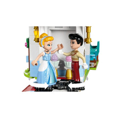 Cinderella in a blue dress dances with a prince near colorful ice cream cones inside a LEGO castle.