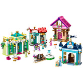 Colorful LEGO® Disney Princess Market Adventure set featuring four detailed buildings, Tiana and Cinderella figures, and various accessories.