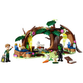 LEGO Elphaba's Retreat construction set featuring a green-skinned character and a boy in formal attire, surrounded by trees, colorful elements, and magical objects.
