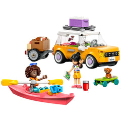 LEGO Friends travel car in vibrant orange with a trailer, two minidolls exploring outdoors, a pink kayak, and a cute puppy figure.