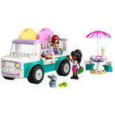 Colorful LEGO® Friends Heartlake City Ice Cream Truck with two minidolls serving ice cream, a cute bunny figure, and a patio table with an umbrella.
