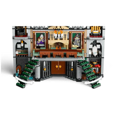 Intricate interior of the LEGO Harry Potter Malfoy Manor set, showcasing two green staircases, a fireplace, and detailed rooms with character portraits.