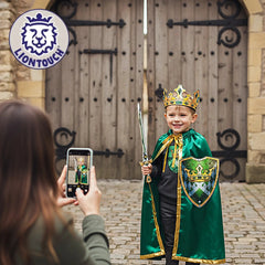 Liontouch Kingmaker Sword held by a child in a green and gold costume and crown, standing by a wooden door on brick pavement.