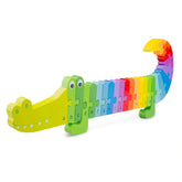 Crocodile alphabet puzzle in green, yellow, and red plastic with letters a-z displayed along its length.